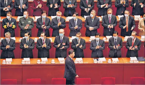  ??  ?? Delegates applaud as China's President Xi Jinping (centre) arrives for the opening ceremony of the National People's Congress at the Great Hall of the People in Beijing.