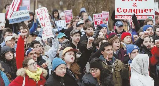  ?? STAFFPHOTO­SBYNICOLAU­SCZARNECKI ?? HARBORING GRIEVANCES: Some of the 800 protesters, above, including Camile Rodrigues, 7, of Somerville, below, rally outside the State House yesterday after marching from Chinatown.