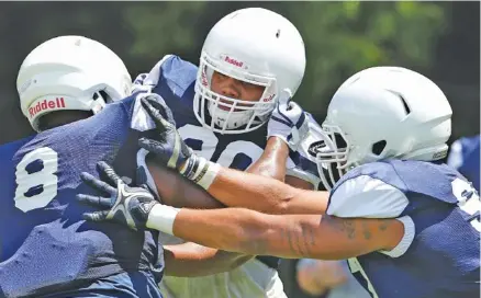  ?? STAFF PHOTO BY ERIN O. SMITH ?? UTC defensive lineman Devonnsha Maxwell, center, participat­es in drills during a preseason practice at Scrappy Moore Field. Maxwell solidified his position during the Mocs’ preseason camp, which concluded Saturday with a two-hour practice at Finley Stadium.