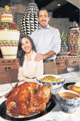  ?? MARK RANDALL/ STAFF PHOTOGRAPH­ER ?? Scott Browne, executive chef at Uncle Julio’s Fine Mexican Food in Boca Raton, and his fiancee, Adria McKinney, show off their Honey chipotle glazed turkey.