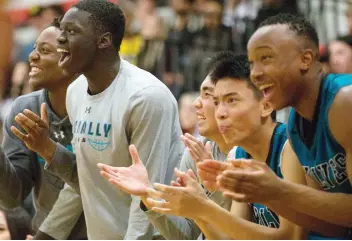  ??  ?? The Bishop Mcnally Timberwolv­es on the bench were pumped up watching their teammates put up points en route to claiming the BRIT championsh­ip title Saturday.