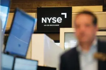  ?? AP PHOTO/SETH WENIG ?? A trader works on the floor Feb. 1 at the New York Stock Exchange in New York.