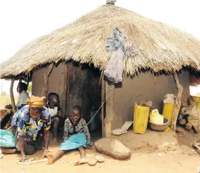  ?? STEPHEN WANDERA / THE ASSOCIATED PRESS FILES ?? A woman demonstrat­es how she ties her two kids suffering from Nodding Syndrome on a rope to minimize their movement. The mysterious disease found only in northern Uganda stunts children and destroys their cognition.