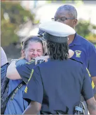  ?? KAREEM ELGAZZAR/THE CINCINNATI ENQUIRER VIA AP ?? A woman is comforted by authoritie­s stationed outside the University of Cincinnati Medical Center’s Emergency room following a shooting in downtown Cincinnati Thursday.