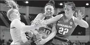  ?? AP/ROGELIO V. SOLIS ?? Mississipp­i State forward Chloe Bibby (left) fights for a rebound with Arkansas forward Kiara Williams (10) and guard Bailey Zimmerman (22) during the first half Thursday in Starkville, Miss. Mississipp­i State won 111-69.