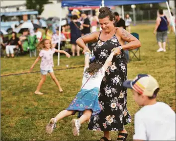  ?? Brian A. Pounds/Hearst Connecticu­t Media ?? Doreen Walsh-Henningsen, of Oxford, swings her daughter Thea, 4, to the music of the band Nardy Boy on Friday at Celebrate Shelton’s 8th Annual Downtown Sounds Summer Concerts.