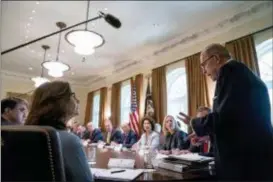  ?? ANDREW HARNIK — THE ASSOCIATED PRESS ?? White House chief economic adviser Larry Kudlow, right, accompanie­d by Secretary of Veterans Affairs Robert Wilkie, left, and CIA Director Gina Haspel, second from left, gives a report on the economy during a cabinet meeting with President Donald Trump, background at left, in the Cabinet Room of the White House, Thursday in Washington.