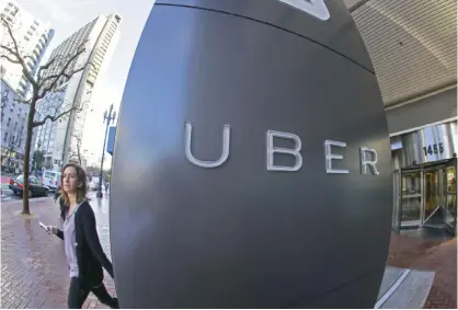  ??  ?? SAN FRANCISCO: In this Tuesday, Dec. 16, 2014 photo, a woman leaves the headquarte­rs of Uber in San Francisco. Venture capitalist­s poured a whopping $48.3 billion into US startup companies last year, investing at levels that haven’t been seen since...