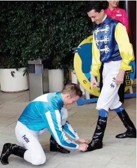  ?? Jockey Club. Picture: Hong Kong ?? SPIT AND POLISH. Zac Purton jokingly polishes Douglas Whyte’s boots at the South African’s farewell meeting in Hong Kong.
