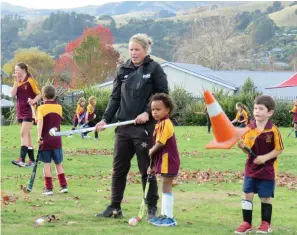  ??  ?? TOP RIGHT Up to 60 children attend Karen’s grassroots hockey programme in Akaroa. Awaiting their turn and watched over by Karen are Nasi Bwayo and Charlie Hyatt.