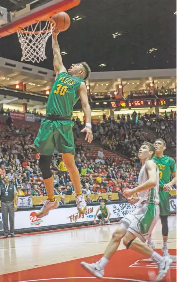  ?? NEW MEXICAN FILE PHOTO ?? Pecos’ Xavier Padilla scores a layup on a fast break during the Class 3A State Basketball Tournament championsh­ip game in The Pit. Pecos beat previously undefeated Texico, 58-44, to win the title. The Wolverines are now district foes for the Panthers, who will log a lot of miles traveling around District 7-2A.