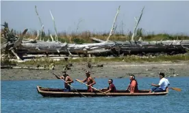  ?? Eureka, California. Photograph: Ben Margot/AP ?? Members of the Wiyot Tribe paddle a dugout redwood canoe across Humboldt Bay in