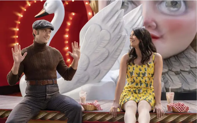  ??  ?? SWAN SONG: Aaron Tveit, left, and Cecily Strong share a meal and a song in ‘Schmigadoo­n!’ on Apple TV+.