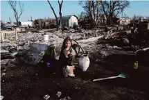  ?? Scott Olson/Getty Images ?? Aurora Champion and her parents help a friend whose home was destroyed by the Smokehouse Creek Fire in Stinnett.