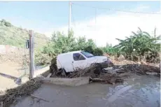  ?? — Reuters ?? A damaged car is seen in the aftermath of the flooding of the Milicia River in Casteldacc­ia, near Palermo.