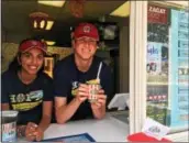  ?? GARY PULEO — DIGITAL FIRST MEDIA ?? At Rita’s Italian Ice of Lansdale, Natasha Camelin, left, and manager Steven Yezzi serve up the store’s most popular water ice flavor, mango, on Thursday.