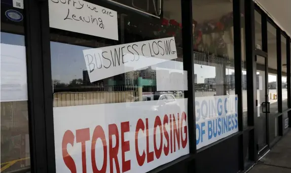  ?? AP FILE ?? GOING OUT OF BIZ: A sign announces a store closing in Niles, Ill. Criminals are seizing on a surge in job losses to steal unemployme­nt benefits from Americans nationwide.