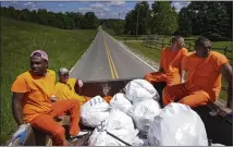  ??  ?? Inmates ride in the back of a truck after picking up litter, in Hickman County, Tennessee. The tax money from beverage companies — and the cleanup crews — would go away if Tennessee enacted a bottle bill, according to a provision in the state’s law.