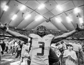  ?? BRETT CARLSEN/GETTY ?? Syracuse’s Ervin Philips enjoys the moment as fans storm the field Saturday after an upset of No. 2 Clemson.