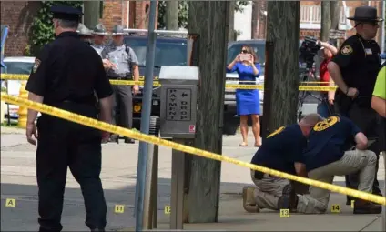  ?? Darrell Sapp/Pittsburgh Post-Gazette via AP ?? This 2017 file photo shows evidence markers being placed on N. Court Street and the sidewalk next to the Jefferson County Courthouse in Steubenvil­le, Ohio, after Jefferson County Judge Joseph Bruzzese Jr. was ambushed and shot earlier in the day.