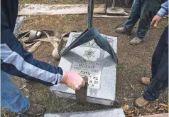  ?? NICK SCHNELLE/THE NEW YORK TIMES ?? Workers lift a toppled gravestone Tuesday at Chesed Shel Emeth Cemetery in University City, Mo., a suburb of St. Louis. Nearly 200 grave markers were vandalized in the 124-year-old Jewish cemetery, leaving people wondering if might be another in a...