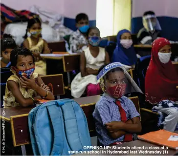  ??  ?? OPENING UP: Students attend a class at a state-run school in Hyderabad last Wednesday (1)