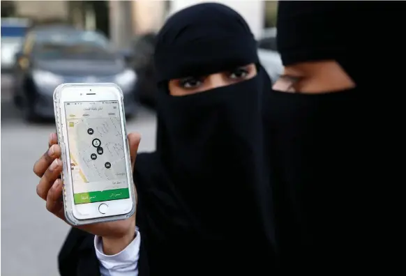  ?? Reuters ?? Using the Careem app in Riyadh. As ride-hailing services gain popularity, Saudi Arabia has partnered with Uber to create 100,000 jobs for drivers