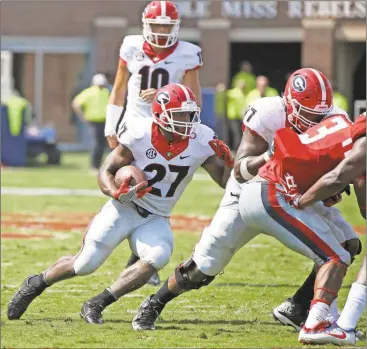  ?? Rogelio V. Solis/AP ?? Georgia running back Nick Chubb (27) runs a play against Mississipp­i in the first half of their NCAA college football game, Saturday, Sept. 24, 2016, in Oxford, Miss. No. 23 Mississipp­i won 45-14.