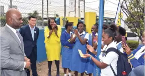  ?? CONTRIBUTE­D ?? Minister of Science, Energy and Technology Dr Andrew Wheatley (left) interacts with students of Merl Grove High School in Kingston on Wednesday. Also pictured (from second left) are president and chief executive officer of the Jamaica Public Service,...