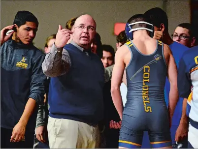  ?? SARAH GORDON/THE DAY ?? Ledyard’s head coach Steve Bilheimer talks to his wrestlers during a match against Windham on January 31 at Ledyard.