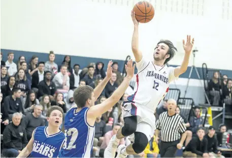  ?? BOB TYMCZYSZYN/STANDARD STAFF ?? Jean Vanier's Raymond Tellier (12) drives to the hoop against Port Colborne Bears Stephen Kapellas (12) during the Tribune basketball tournament Thursday.