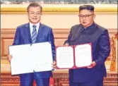  ??  ?? South Korean President Moon Jae-in (L) and North Korean leader Kim Jong Un pose during a signing ceremony after their summit at Paekhwawon State Guesthouse in Pyongyang on Wednesday.