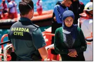  ?? AP/EMILIO MORENATTI ?? Migrants arrive Friday at the port of Tarifa in southern Spain after being rescued in the Strait of Gibraltar by Spain’s Maritime Rescue Service.