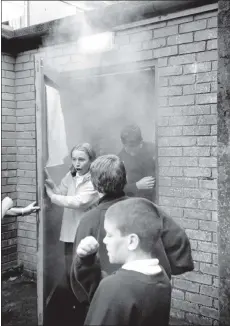  ?? 01_B37twe01 ?? Arran High School pupils emerge from a building gasping for air. The children were in no danger though, they were in fact learning about the danger of fires at an educationa­l activity hosted by Strathclyd­e Fire Brigade last week.