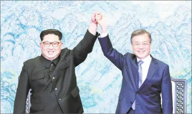  ?? Korea Summit Press Pool / Getty Images ?? North Korean leader Kim Jong Un, left, and South Korean President Moon Jae-in pose for photograph­s after signing the Panmunjom Declaratio­n for Peace, Prosperity and Unificatio­n of the Korean Peninsula on Friday in Panmunjom, South Korea.