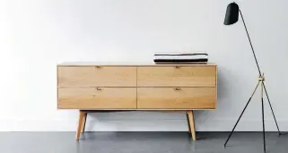  ?? PHOTO COURTESY OF KASTELLA ?? There has been a shift recently from dark wood to lighter tones in furniture, as with this four-drawer dresser, for example, which is made of white oak.