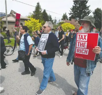  ?? PHOTOS: JASON PAYNE/PNG ?? About 80 people marched through Point Grey near Jericho Beach on Saturday as part of the “Billionair­e Bash,” protesting housing prices and land speculatio­n and how those factors affect housing affordabil­ity in Vancouver.