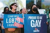  ?? IMAGES JOE RAEDLE/GETTY ?? Anasofia Pelaez, left, and Kimberly Blandon protest in front of Florida State Sen. Ileana Garcia’s office after the passage of the Parental Rights in Education bill, dubbed the “Don’t Say Gay” bill by LGBTQ activists on March 9 in Miami.