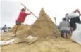  ?? Eric Gay, AP ?? Residents fill sandbags on Thursday in Corpus Christi, Texas, as they prepare for Hurricane Harvey.