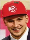  ?? .GETTY IMAGES ?? Luka Doncic briefly wore a Hawks cap on draft night before being traded to Dallas for guard Trae Young.