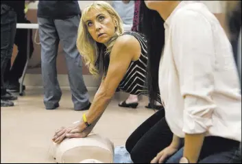  ?? Loren Townsley @lorentowns­ley ?? Tina Merced practices CPR on a mannequin at the East Las Vegas Community Center. AB85 would require all public and private schools to teach CPR and how to use an automated external defibrilla­tor in junior and high school health classes.