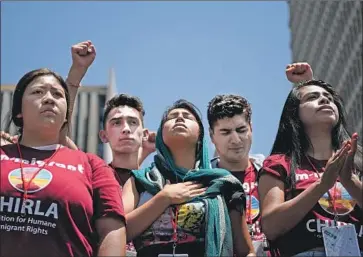  ?? Wally Skalij Los Angeles Times ?? PROTESTERS LISTEN to a speech Saturday during a downtown L.A. demonstrat­ion against the Trump administra­tion’s immigratio­n policies, one of several hundred rallies in cities and small towns across the U.S.