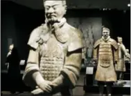  ?? STEVE HELBER — THE ASSOCIATED PRESS ?? In a Tuesday photo, visitors look over some of the Terracotta Army soldiers on exhibit at the Virginia Museum of Fine Arts in Richmond, Va. The Museum has 10 of the majestic terracotta figures on display as part of an exhibit that tells the story of...