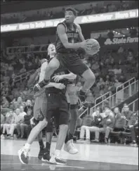  ?? The Associated Press ?? BUZZ CITY: Charlotte guard Malik Monk (1) passes to a teammate Sunday in the second half of the Hornets’ 124-123 loss to the Hawks in Atlanta.