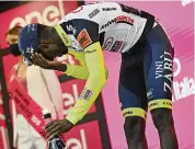  ?? MASSIMO PAOLONE / LAPRESSE ?? Eritrea’s Biniam Girmay was taken to a hospital after getting injured when he popped a champagne cork into his eye while celebratin­g his historic stage victory in Italy. He had become the first Black African to win a stage at a grand tour.