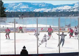  ?? RICH PEDRONCELL­I/AP PHOTO ?? Members of the Colorado Avalanche, in white, and the Vegas Golden Knights, red play during the first period of Saturday’s Outdoor Lake Tahoe game in Stateline, Nev.