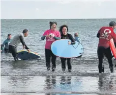  ?? ?? People take part in the Wave Project at the Scarboroug­h Surf Festival.