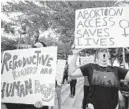  ?? DIRK SHADD/AP ?? Sawyer Xaview, left, and Faelyn Cowan, both from Tampa, hold pro-choice signs at a prochoice rally May 3 in Tampa.