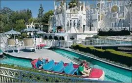  ??  ?? A SOCIALLY distanced guest boat heads toward It’s a Small World on Friday.