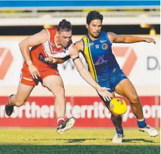  ??  ?? Waratah’s Jamie Smith challenges Wanderers Daniel Weetra in the NTFL Premier League at TIO Stadium last night